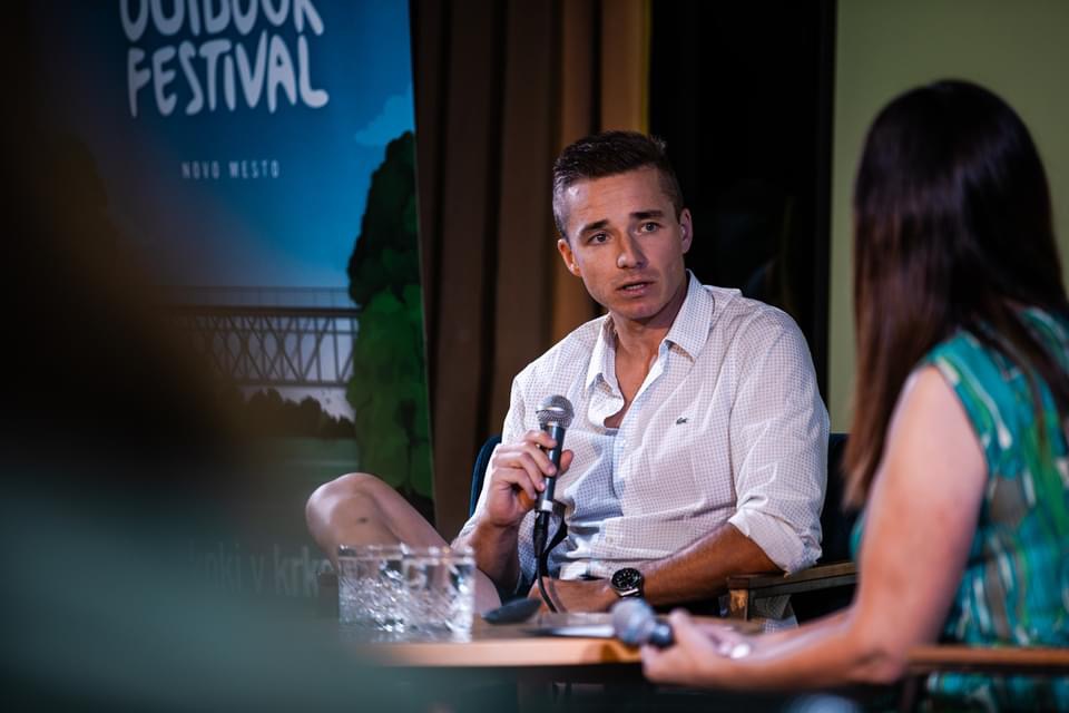 Žiga speaking at an outdoor festival event